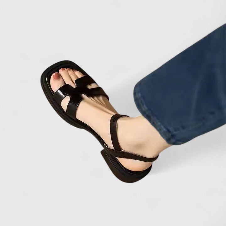 Women wearing leather block heel sandals with adjustable ankle strap