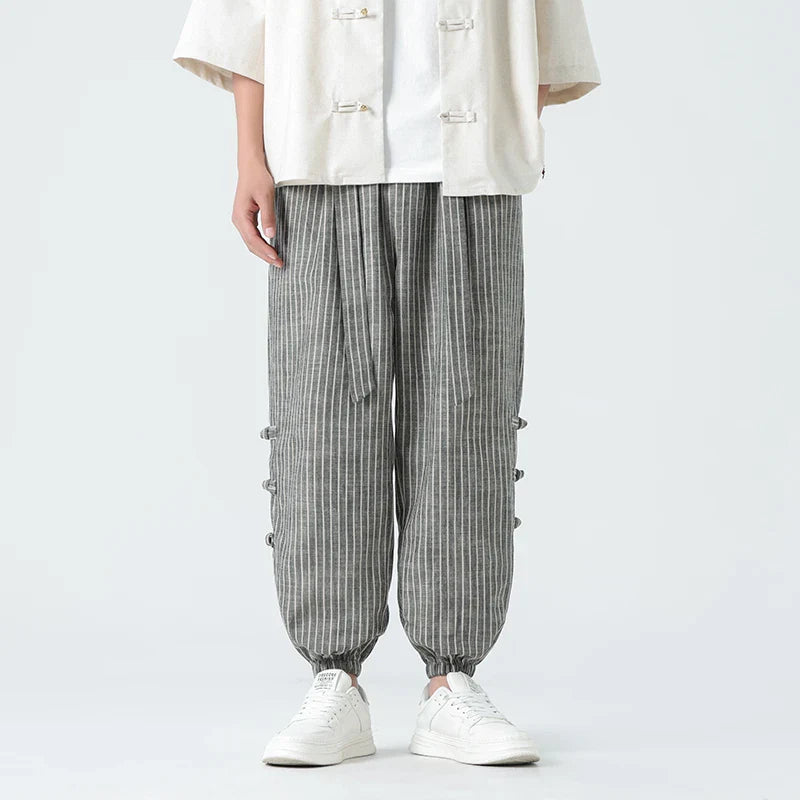 Menโs striped linen tapered trousers with elastic drawstring waistband and cuffed ankles for casual summer wear