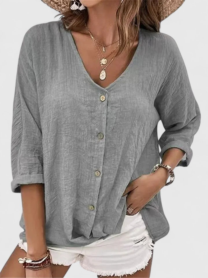 Women wearing a lightweight V-neck blouse with button detail