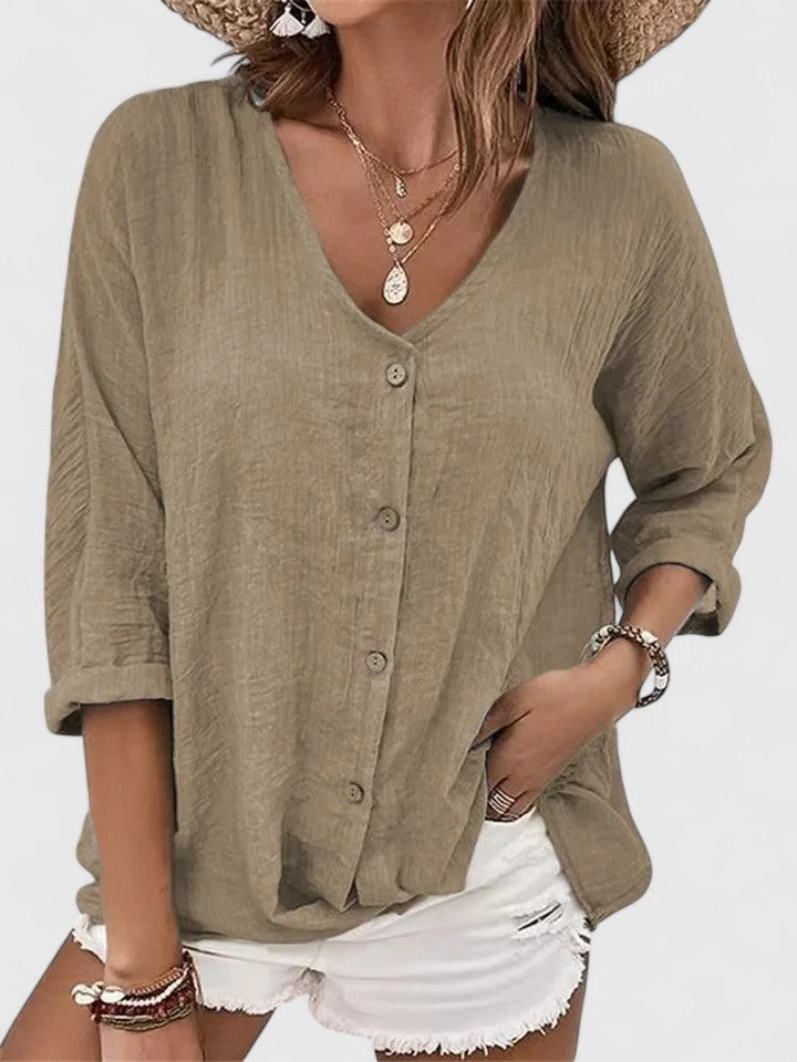 Women wearing a lightweight V-neck blouse with button detail