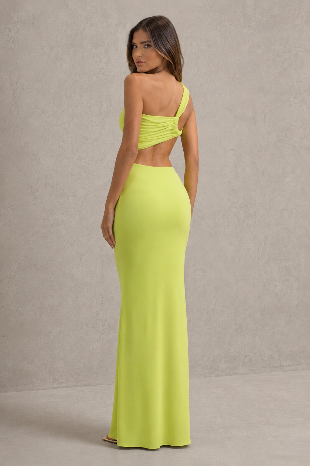 Womenโs asymmetric cut-out jersey maxi dress with sculptural neckline, fitted silhouette and elegant wrap-style floor-length skirt.