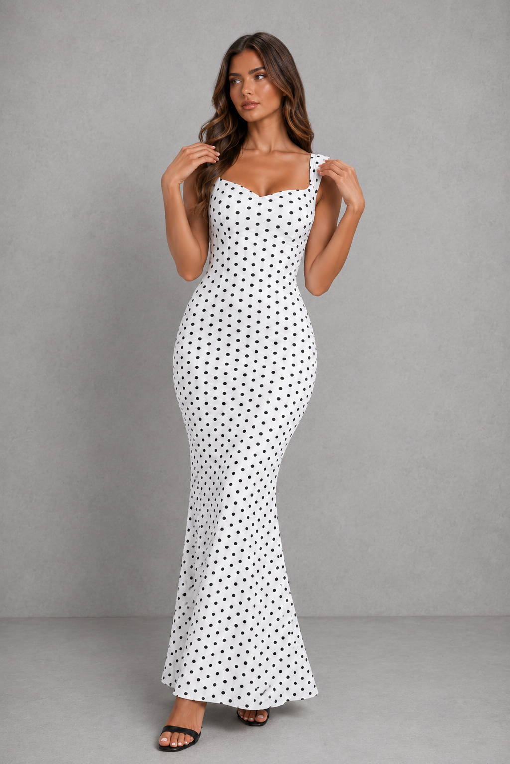 Women’s backless polka dot maxi dress with statement bow detail, sleeveless design, and flattering body-skimming silhouette.