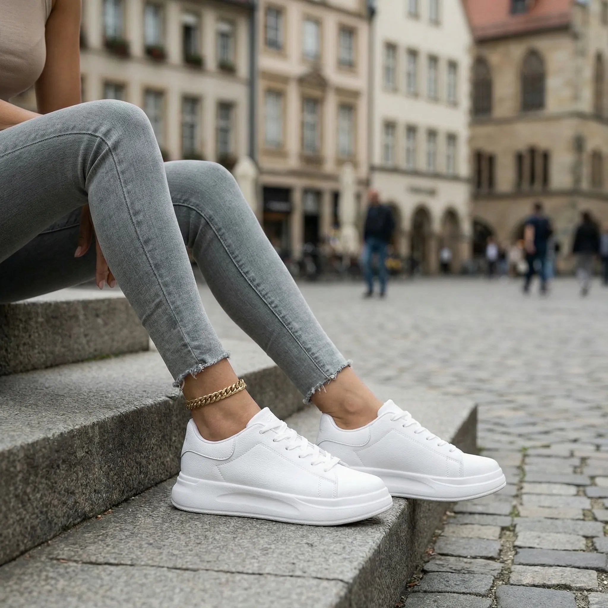 Women’s clean white casual sneakers with cushioned sole and lace-up closure