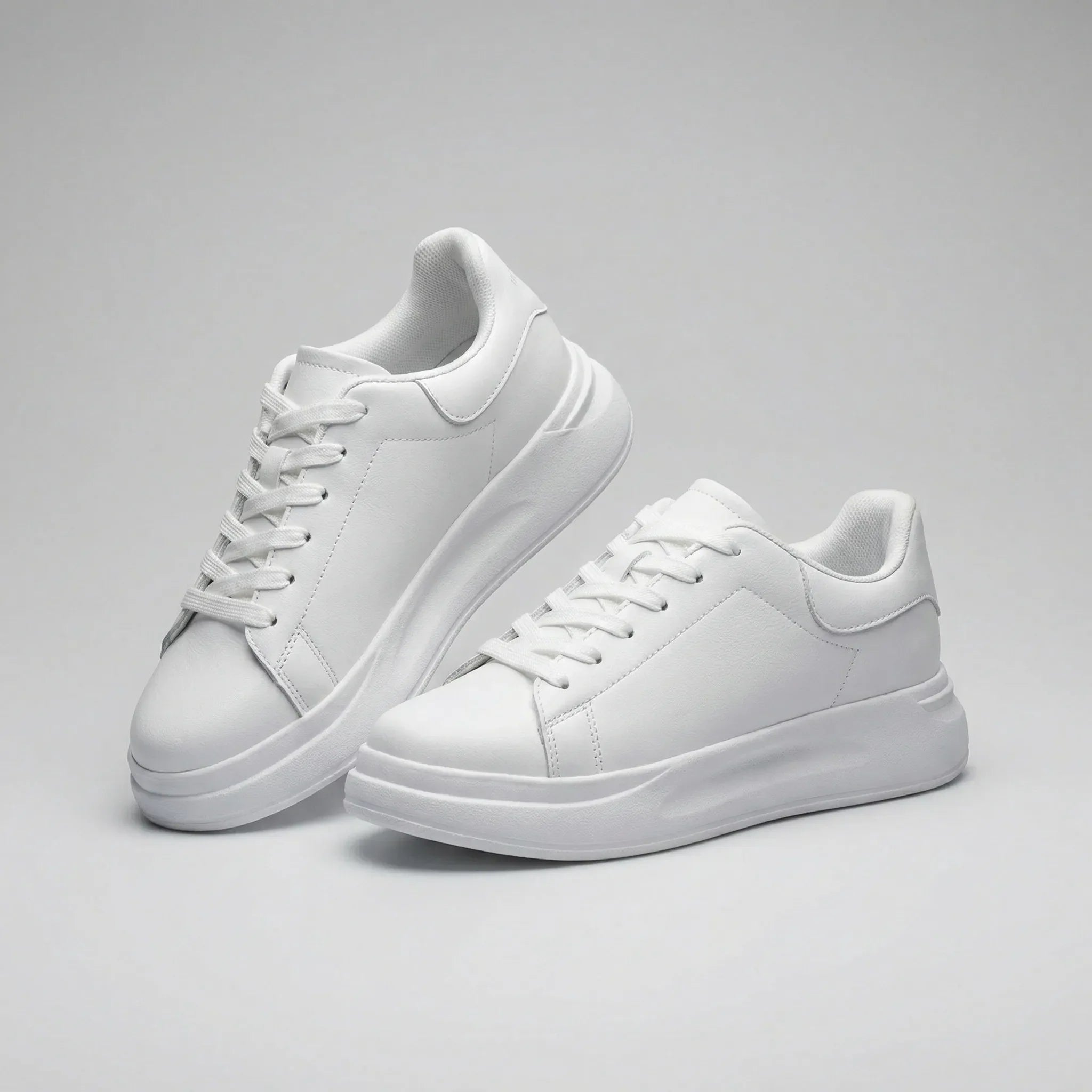 Women’s clean white casual sneakers with cushioned sole and lace-up closure