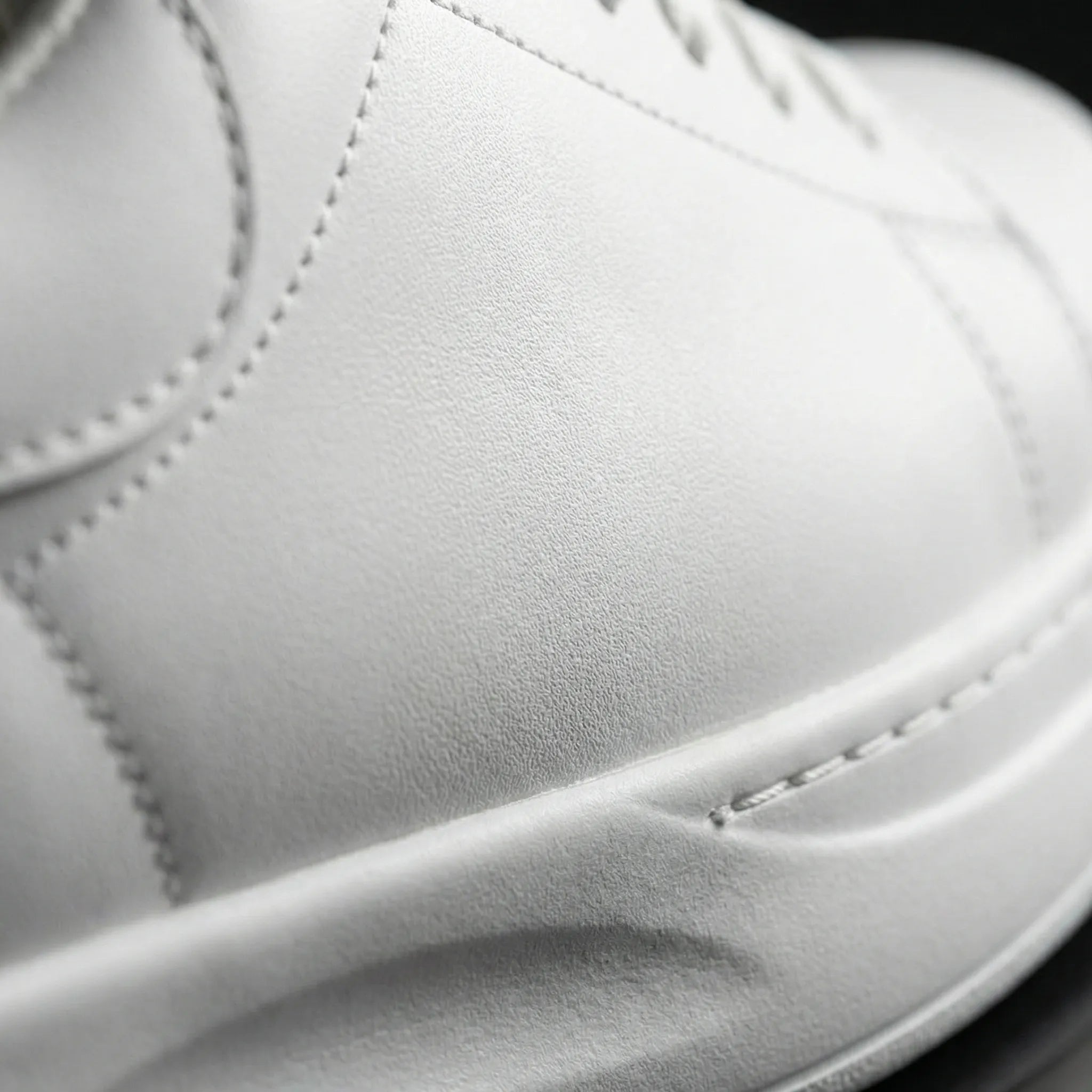Women’s clean white casual sneakers with cushioned sole and lace-up closure
