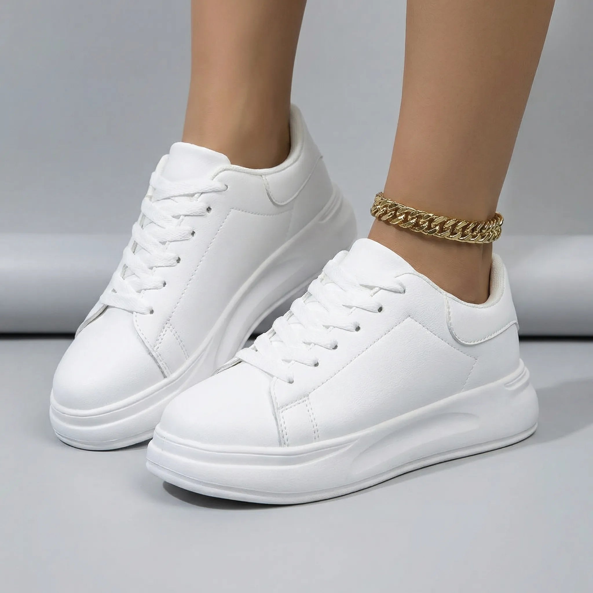 Women’s clean white casual sneakers with cushioned sole and lace-up closure