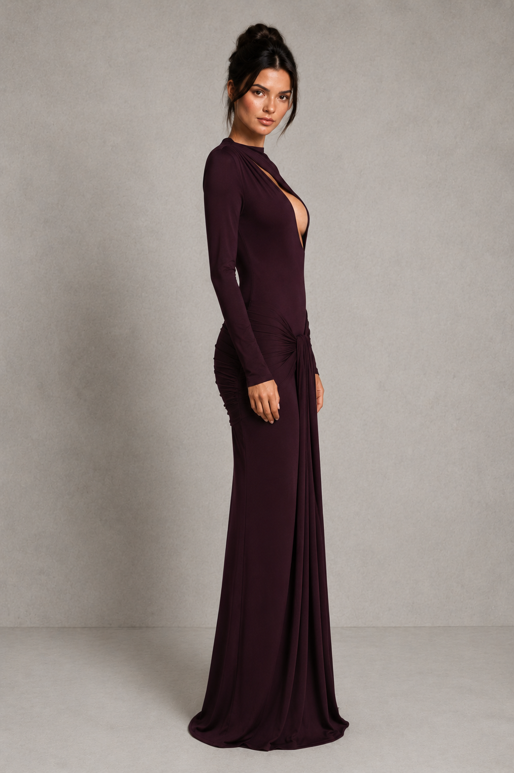 Women's black cut-out maxi dress with a high neckline, long sleeves, draped tie-front hip detail, and fitted stretch silhouette for evening and formal occasions.