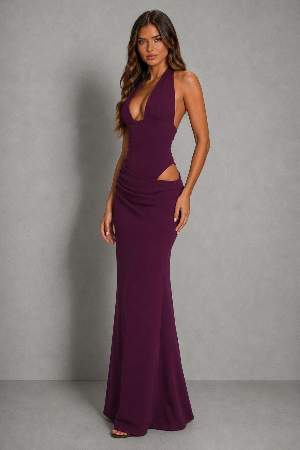 Women’s halter cut-out maxi dress with plunging neckline, asymmetrical waist detail, ruched hips, and a flowing floor-length skirt.