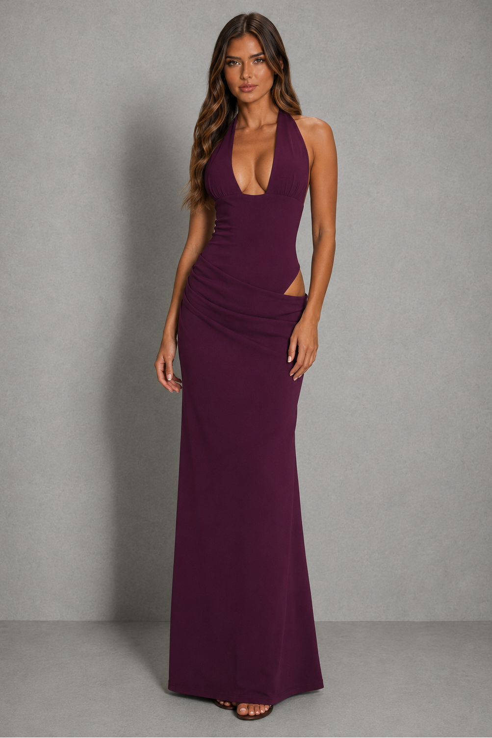 Women’s halter cut-out maxi dress with plunging neckline, asymmetrical waist detail, ruched hips, and a flowing floor-length skirt.