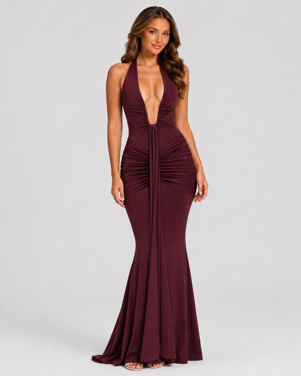 Womenโs halter maxi dress in soft stretch jersey featuring a plunge neckline with U-wire detail, gathered draping, a flowing full-length skirt with train, and a dramatic front draped panel for an elegant occasionwear look.