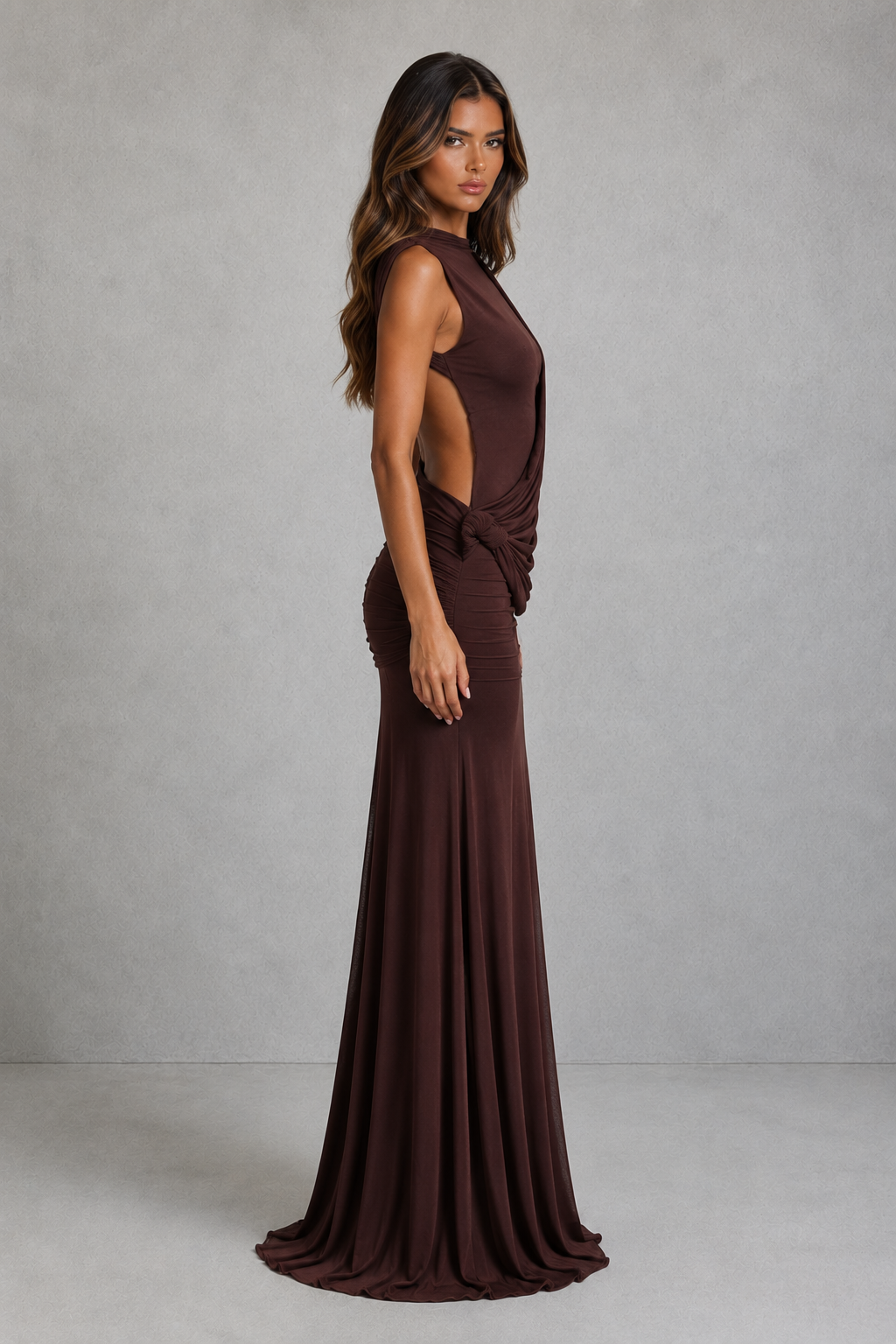 Womenโs high neck mesh maxi dress with diagonal sash detail, ruched hips, asymmetric open back and flowing flared skirt.
