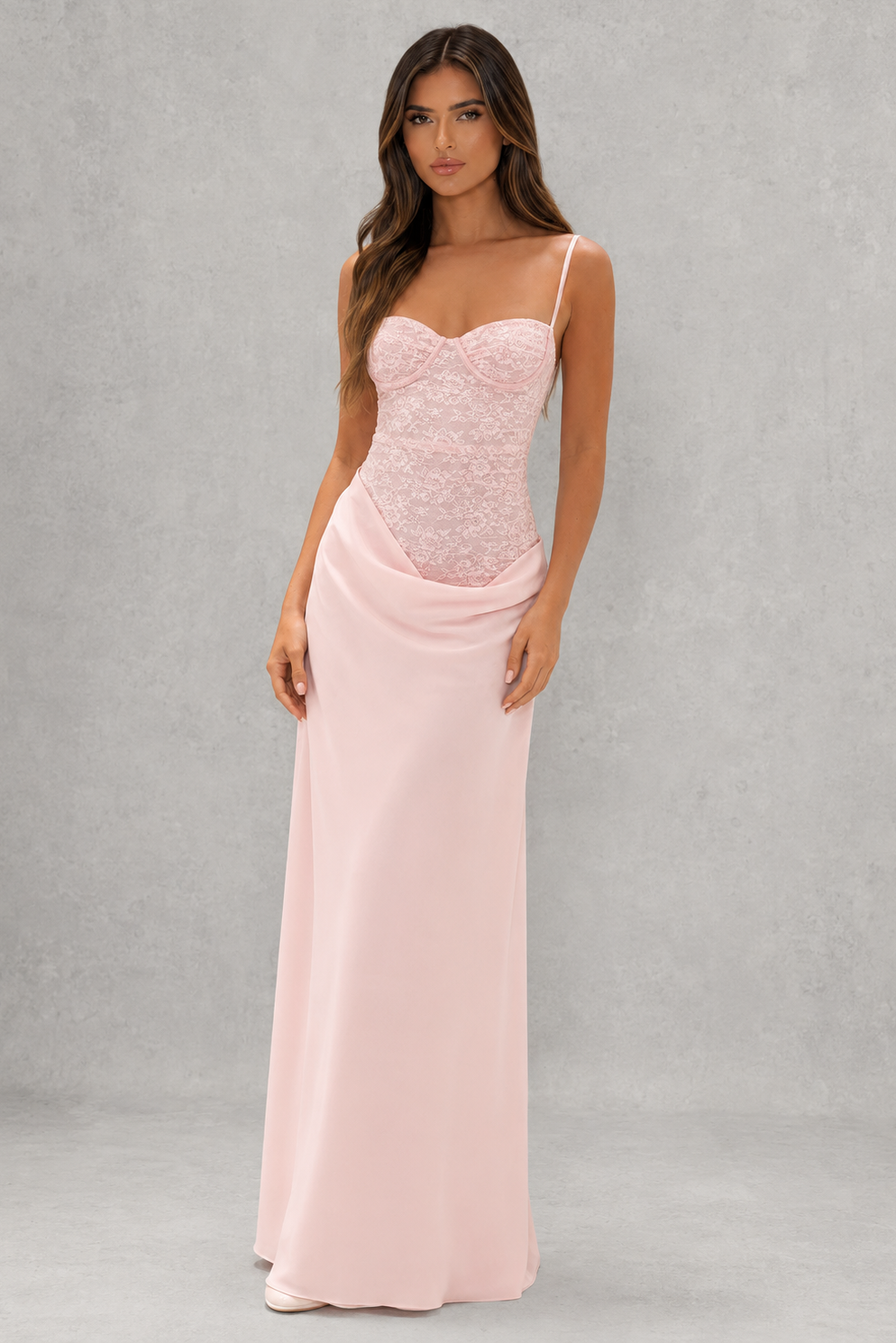 Women's lace bodice maxi dress with pleated cups, adjustable shoulder straps, draped hip detail, and a flowing skirt, designed for evening events, weddings, and formal occasions.