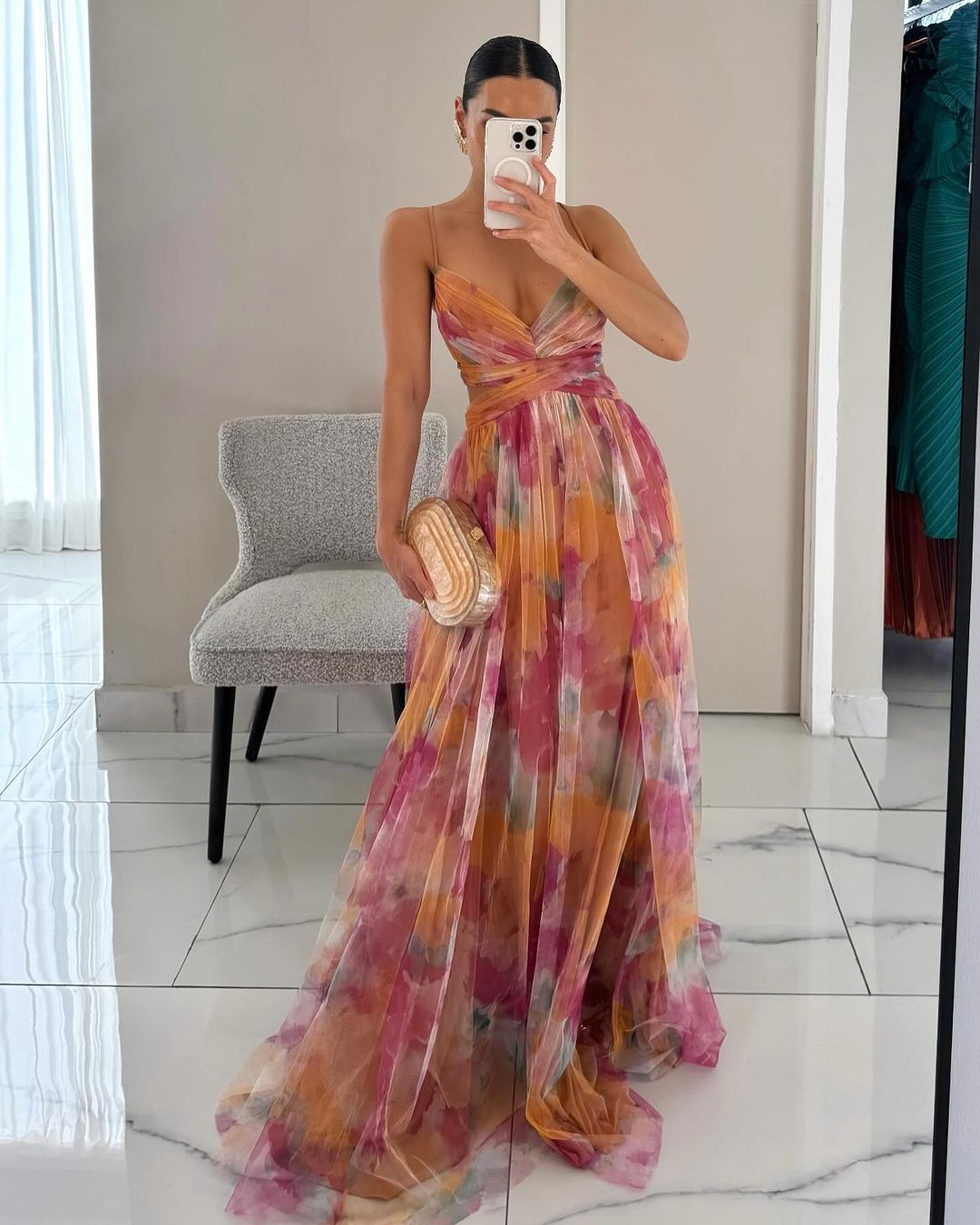 Women’s layered formal dress with flowing silhouette and soft painterly colors