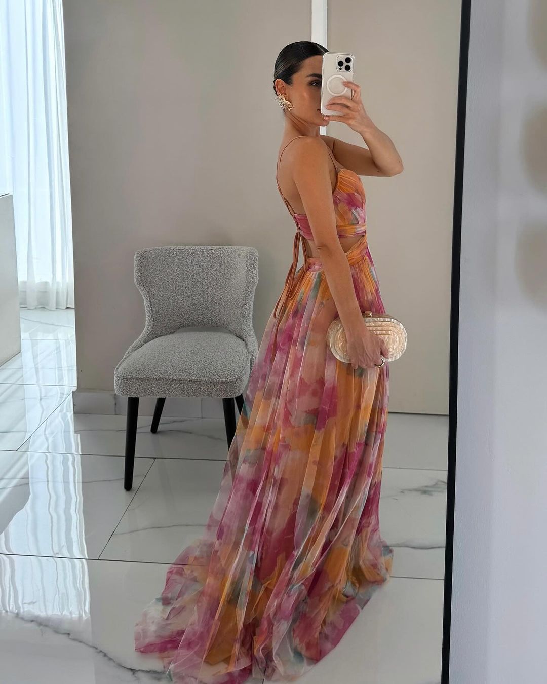Women’s layered formal dress with flowing silhouette and soft painterly colors