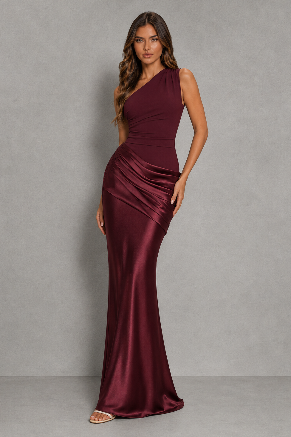 Women’s one-shoulder maxi dress with asymmetrical neckline, draped pleat detailing, fitted crepe bodice, and flowing full-length skirt.