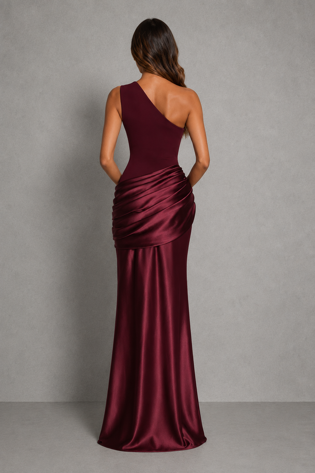 Women’s one-shoulder maxi dress with asymmetrical neckline, draped pleat detailing, fitted crepe bodice, and flowing full-length skirt.