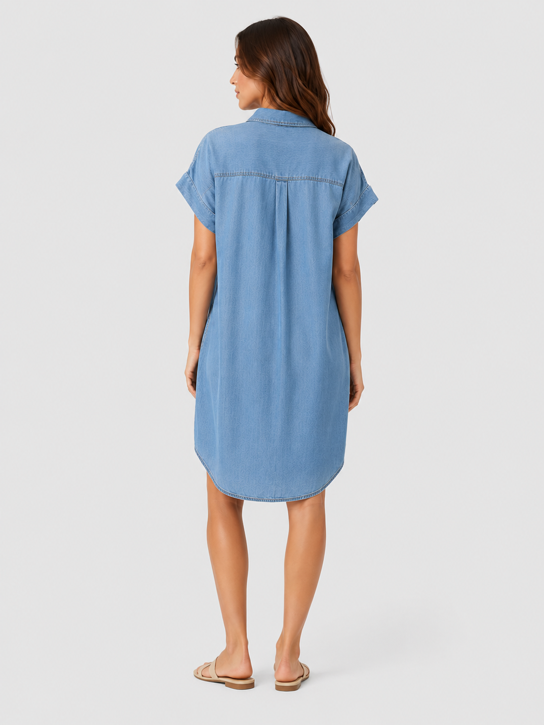Woman wearing a light blue lightweight summer mini dress with a relaxed fit against a neutral background.