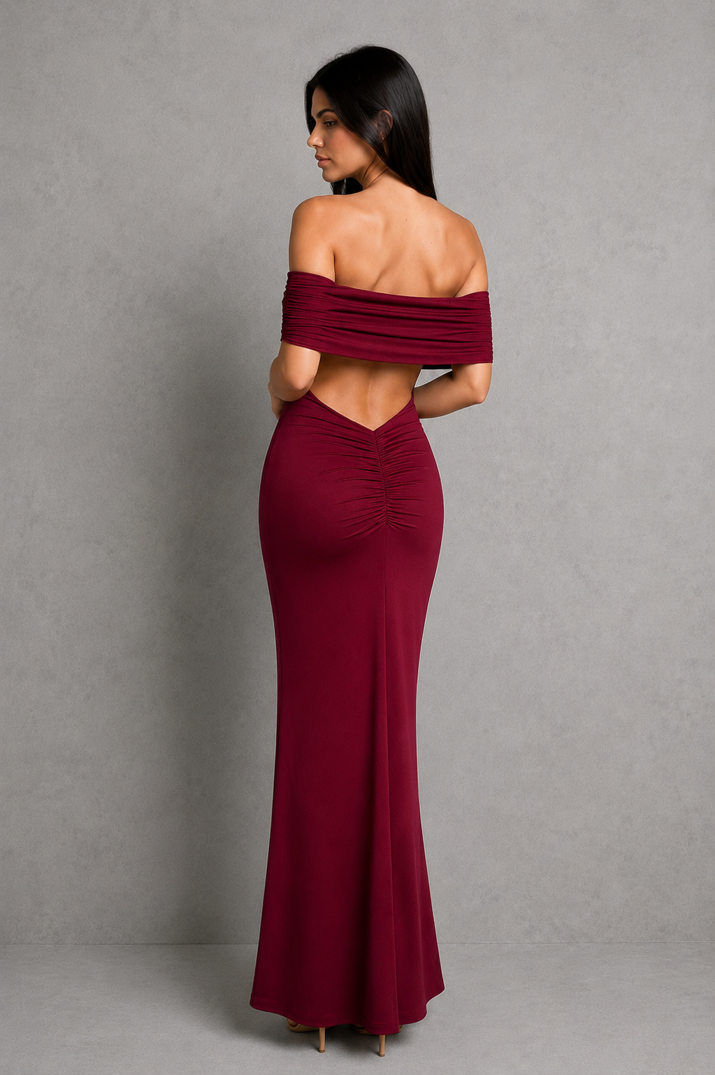 Woman wearing an elegant off-shoulder pleated maxi dress featuring a fitted bodice and flowing floor-length skirt, ideal for weddings, formal events, and evening occasions.