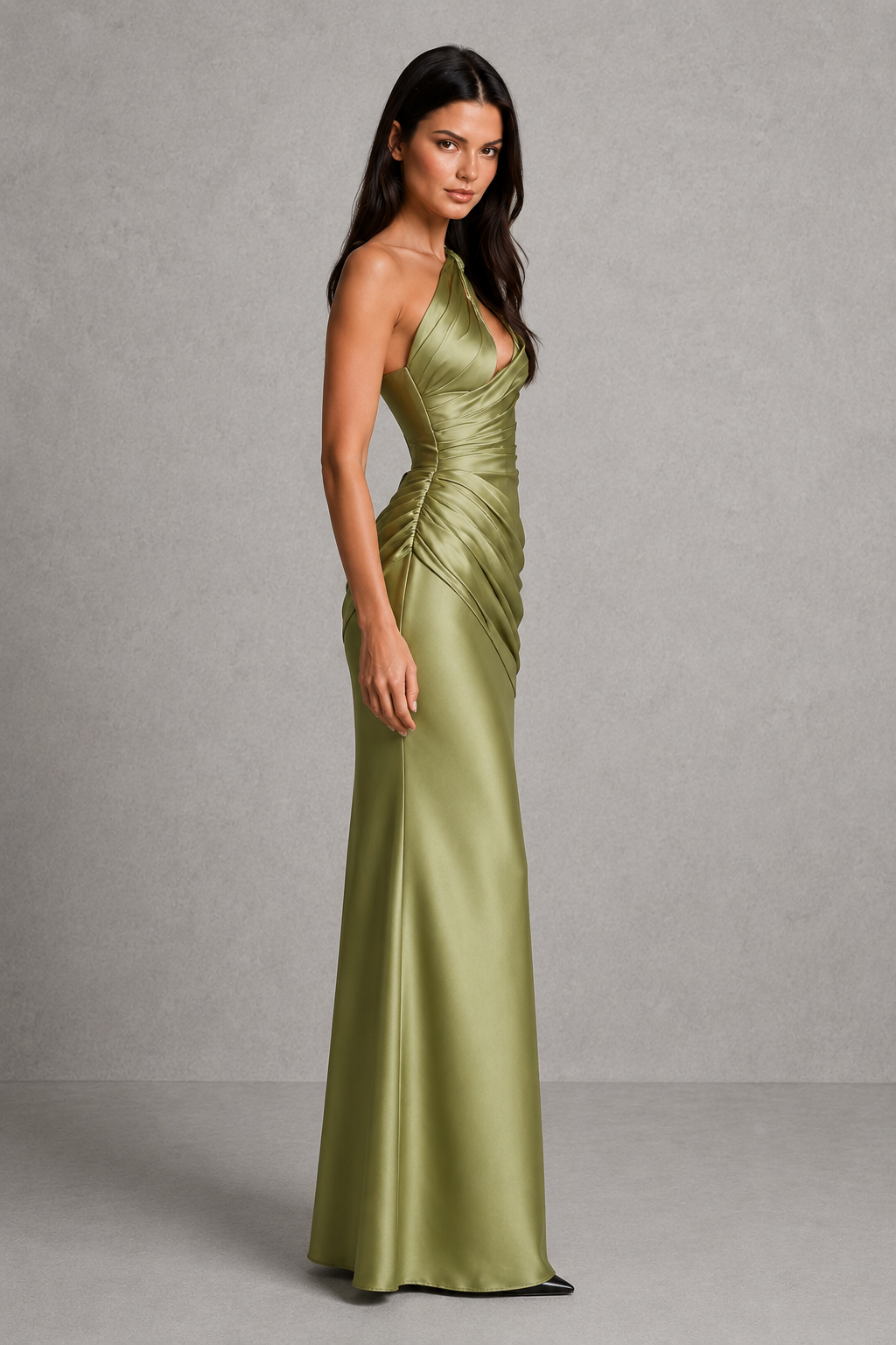 Woman wearing a one-shoulder satin maxi dress featuring a structured corset bodice, asymmetrical neckline, plunge cut-out detail, draped hip panel, and flowing bias-cut skirt, designed for elegant evening events and formal occasions.