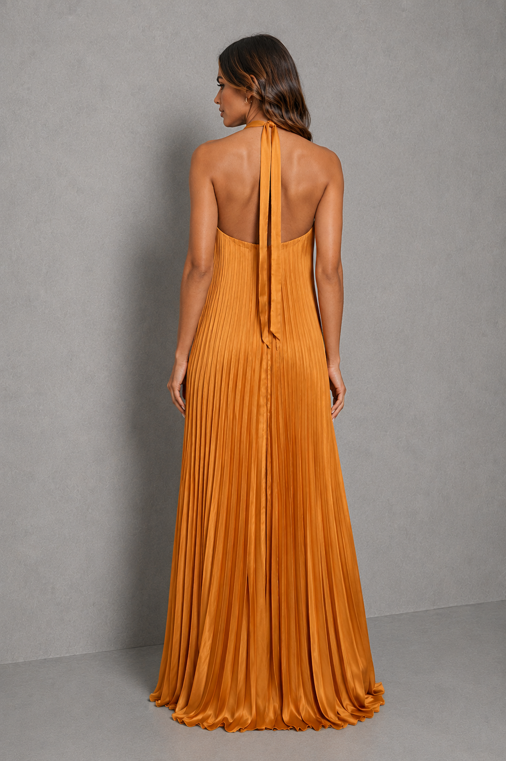 Women's pleated halterneck maxi dress with a cross-front neckline, open back with adjustable tie fastening, and flowing floor-length pleated skirt, ideal for wedding guests, formal occasions, and evening wear.