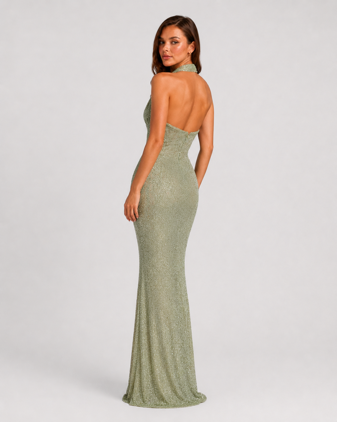 Women's sequin halter neck maxi glitter dress with a deep plunge neckline, open back, fitted bodice, defined waist, and flowing floor-length skirt for elegant evening occasions.