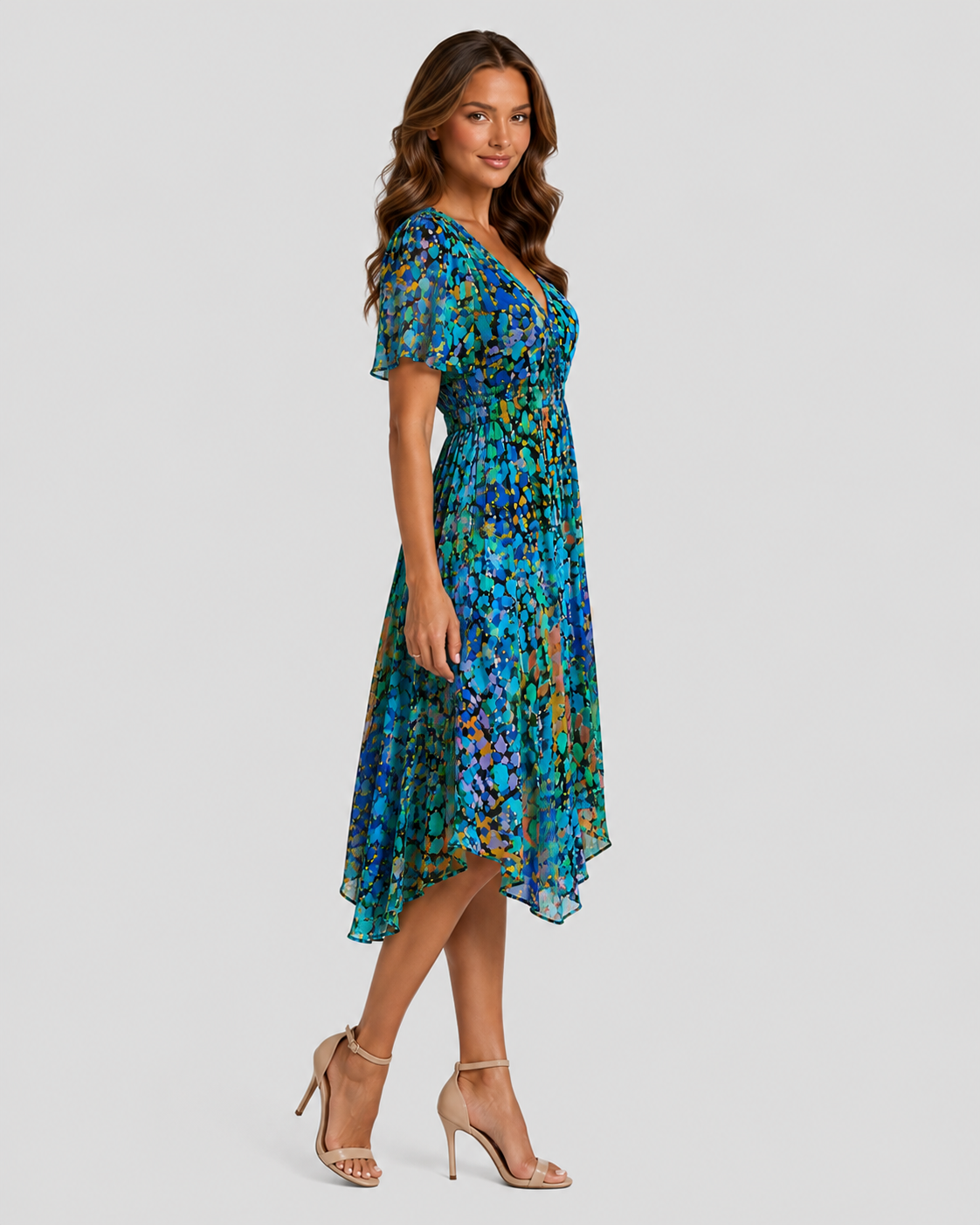 Women's printed midi dress with a V-neckline, softly defined waist, and flowing asymmetric hem, featuring a vibrant all-over print for summer and casual wear.
