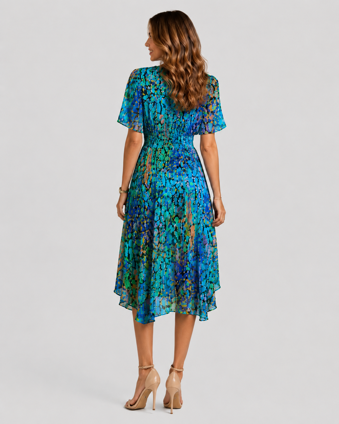 Women's printed midi dress with a V-neckline, softly defined waist, and flowing asymmetric hem, featuring a vibrant all-over print for summer and casual wear.