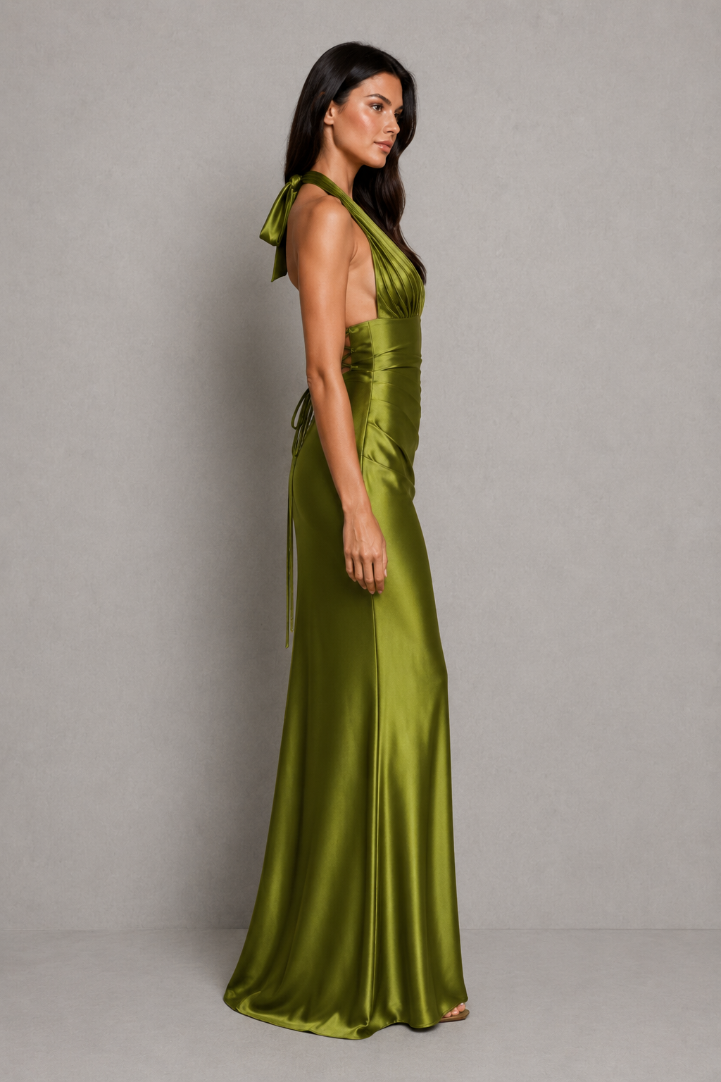 Women's satin halter maxi dress with a plunge neckline, sculptural pleated cups, asymmetric pleated bodice, and flowing bias-cut skirt. Features an internal corset bodice and adjustable lace-up back for a flattering, elegant silhouette ideal for evening events, formal occasions, and special celebrations.