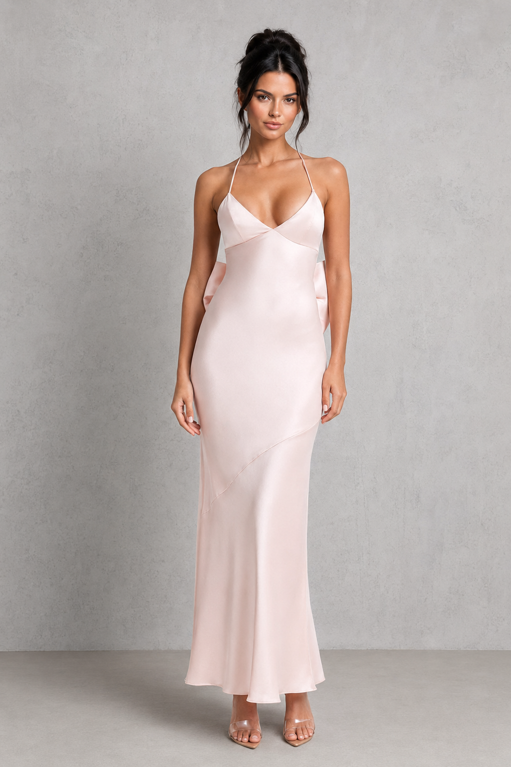 Women's satin maxi dress featuring a fitted silhouette, triangle cup bodice, adjustable crossover straps, low V-shaped open back, and removable bow detail, ideal for bridal events, rehearsal dinners, and formal occasions.