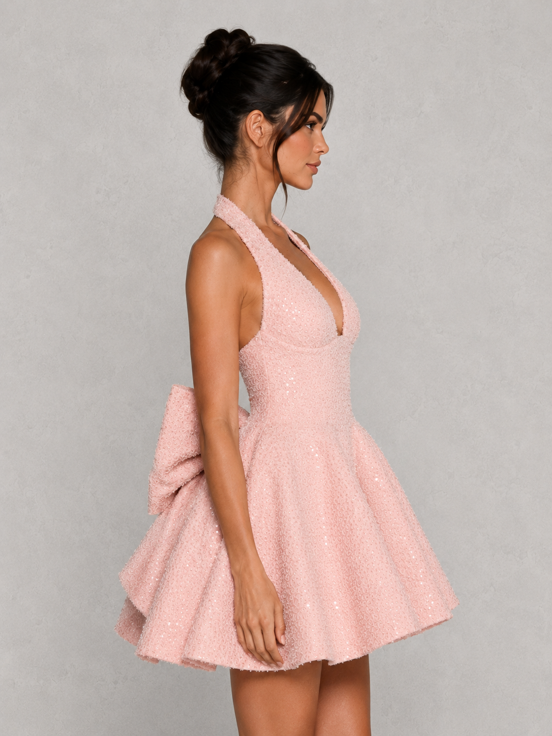 Women’s sequin tweed mini dress featuring a halter neckline, structured mono-underwire bodice, full circular skirt, and oversized detachable bow at the back, designed for parties, weddings, and special occasions.