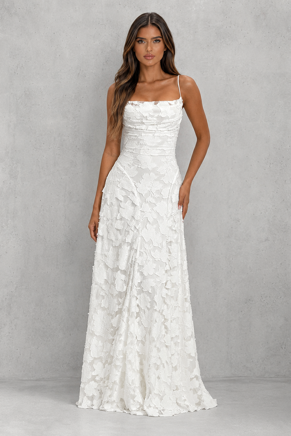 Women’s textured floral maxi dress with delicate shoulder straps, sculpted fitted bodice, defined waist, and flowing full-length skirt.