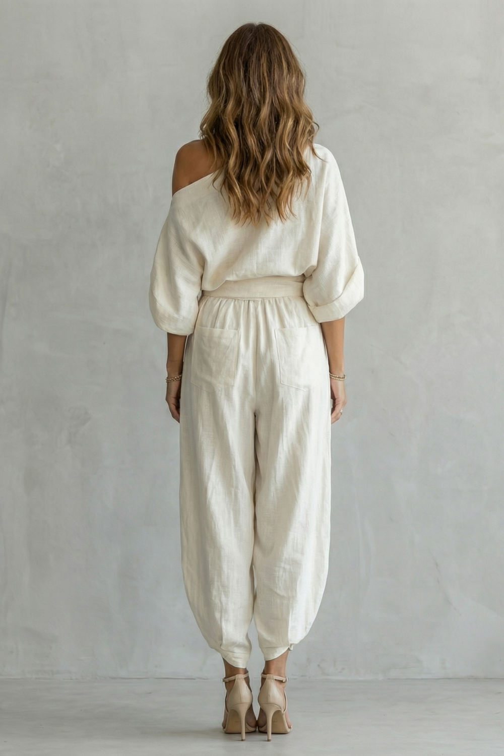 Off White colorway of the off-shoulder top and tapered pants set, full-length view