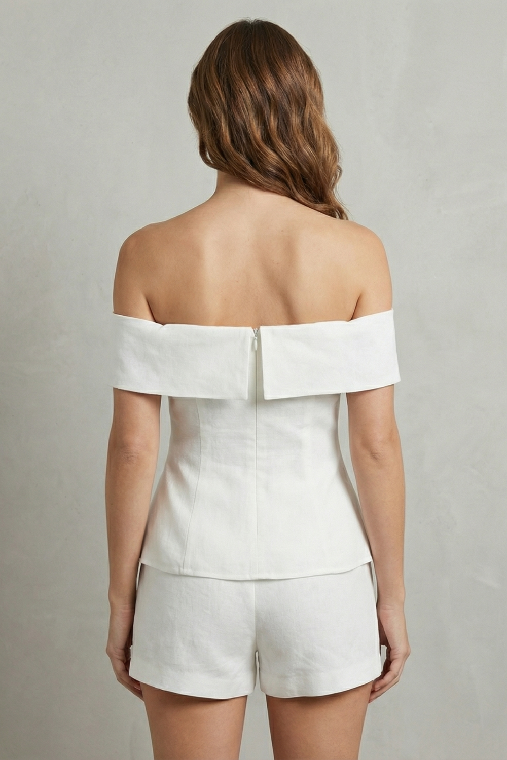 Detail close-up of the off-shoulder neckline and peplum waist