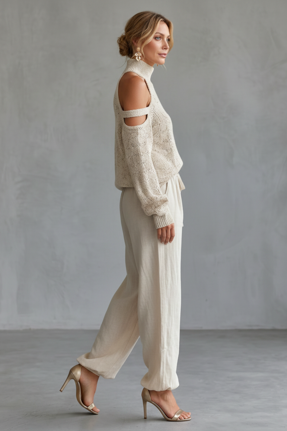 Detail close-up of the open-shoulder cut-out and high neckline