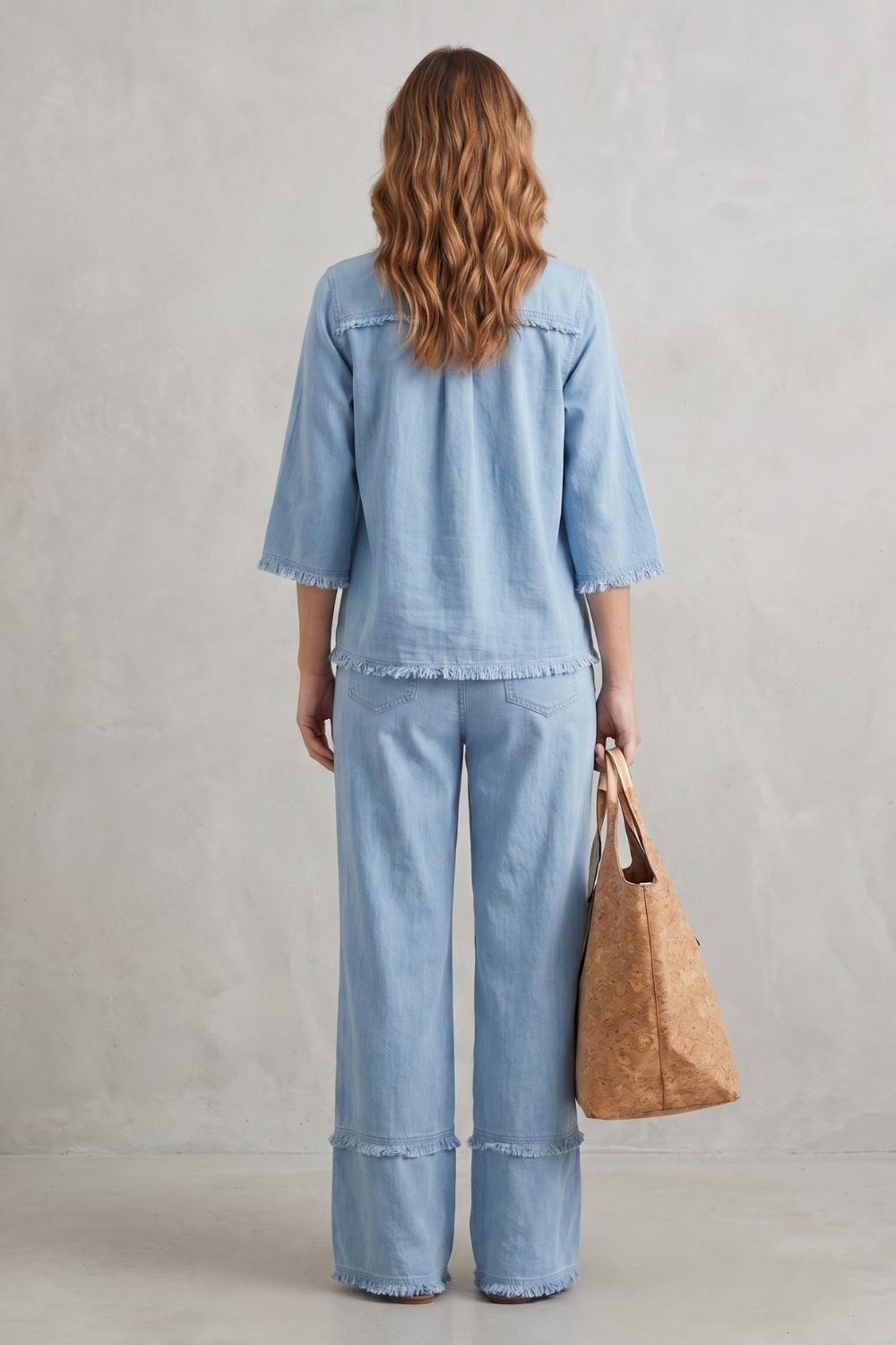 Detail close-up of the raw hem finish on the linen blend top