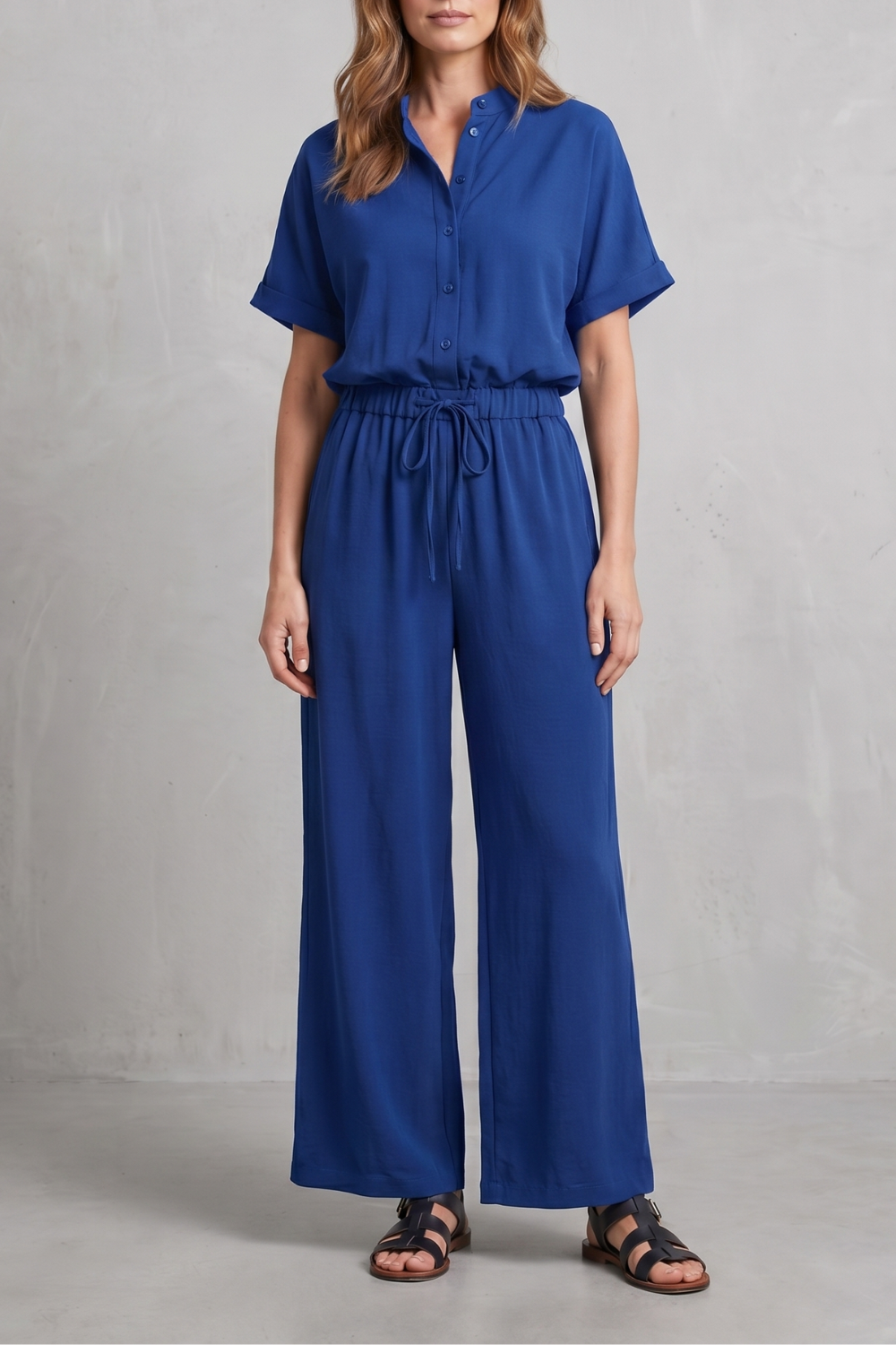 Seated view showing the relaxed drape of the wide-leg pants