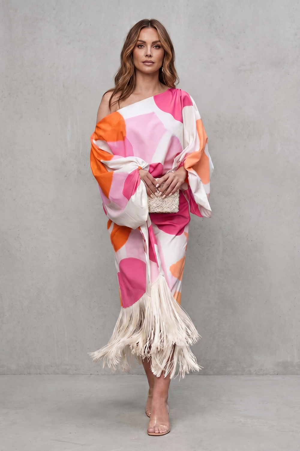 Pink colorway of the off-shoulder abstract print set, styled with heels
