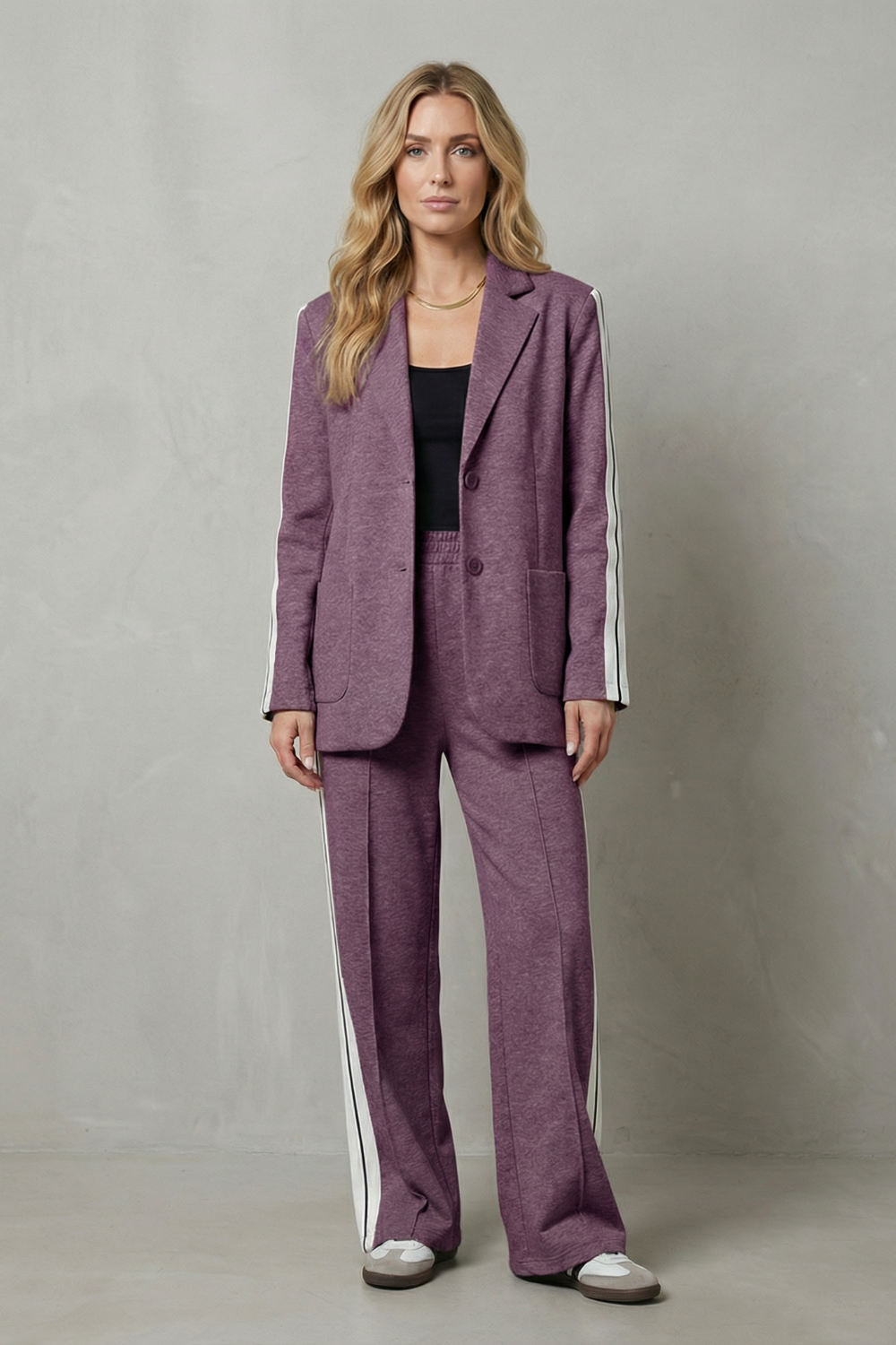 Full-length styled view of the side-stripe blazer and pants set