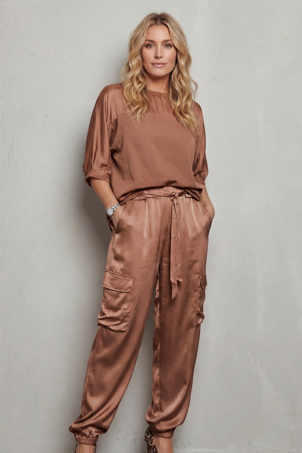 Gray colorway of the satin top and cargo pants set, full-length view