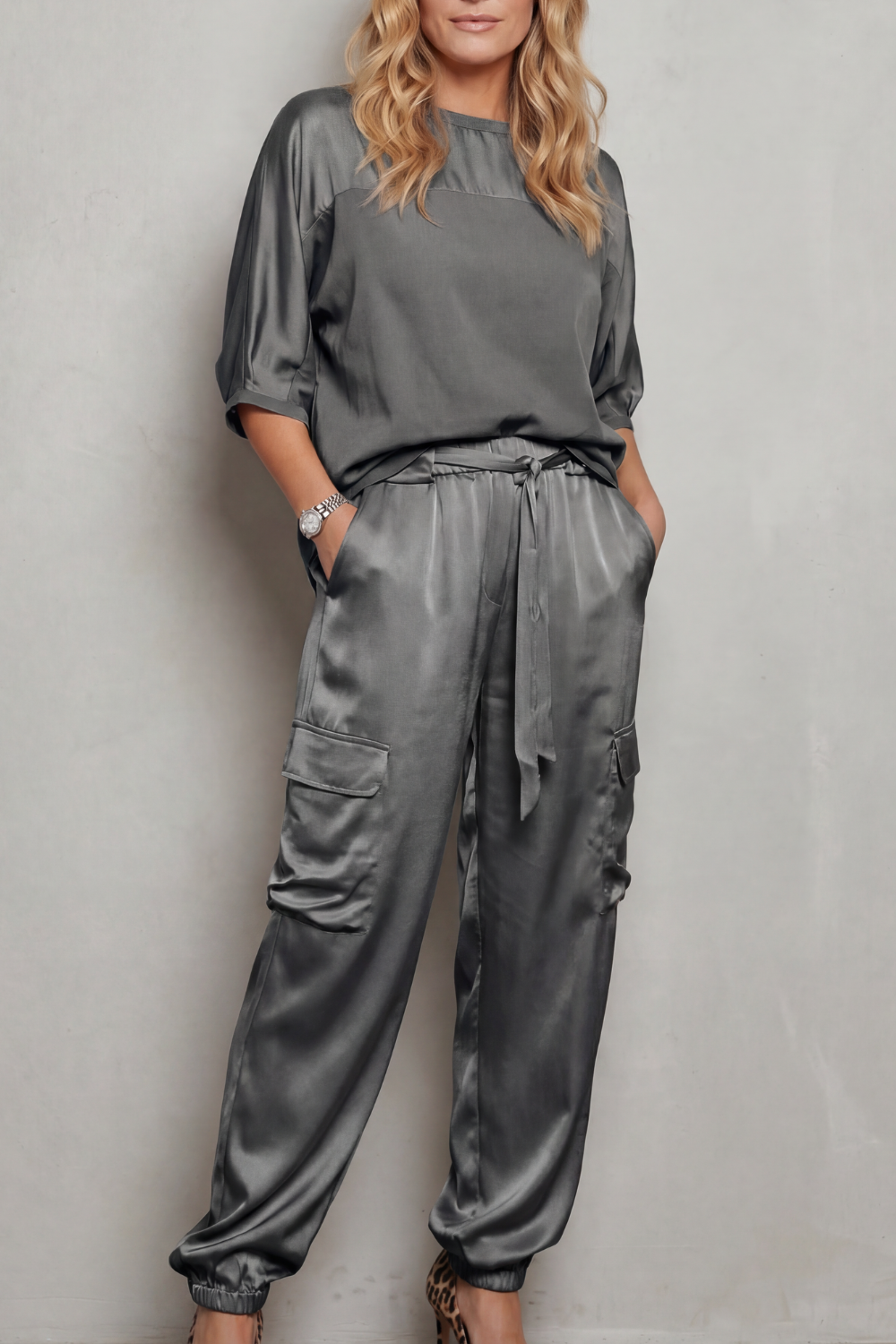 Seated view of the relaxed satin top and cargo pants lounge set