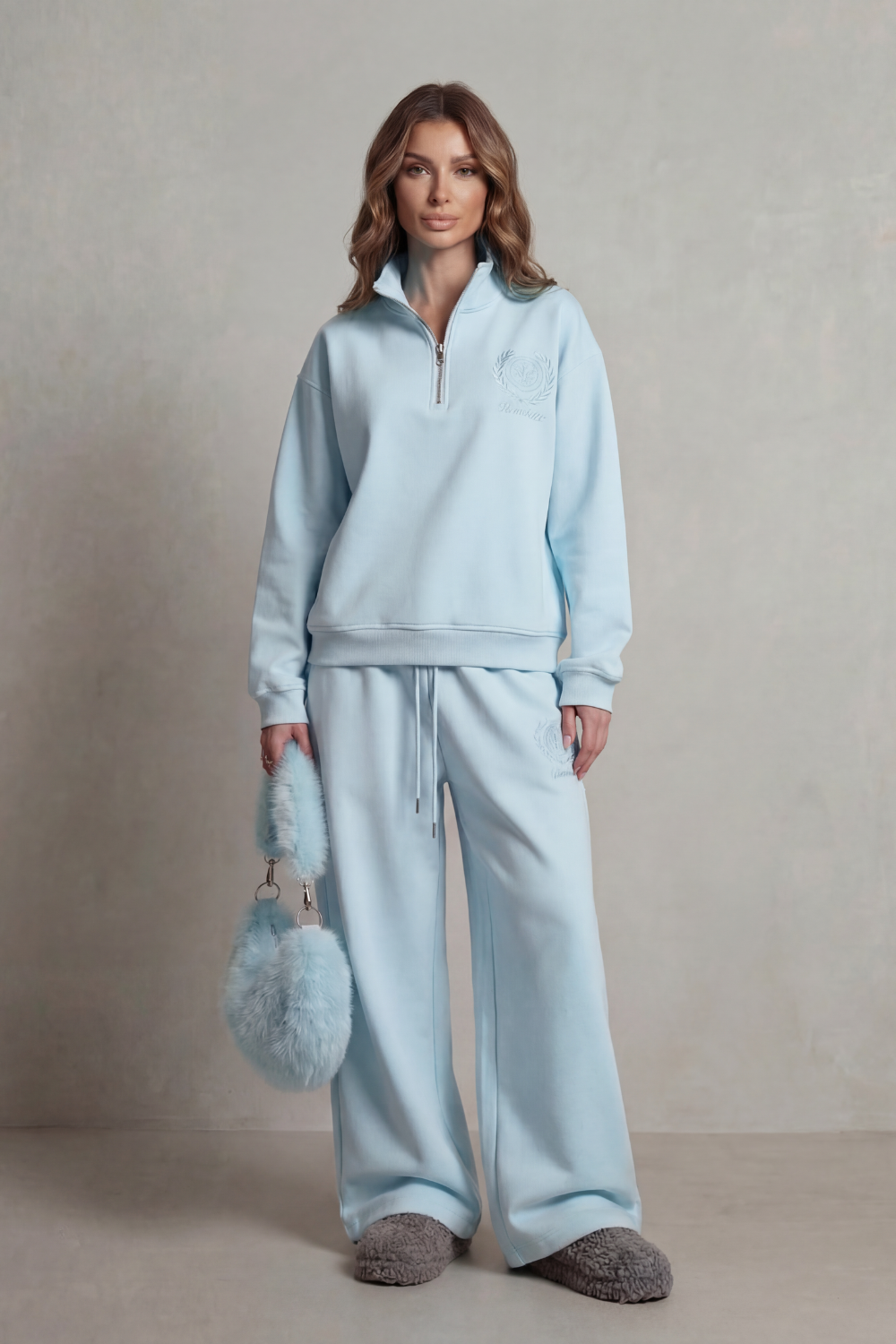 Lounge set styled with plush sliders and a faux-fur bag