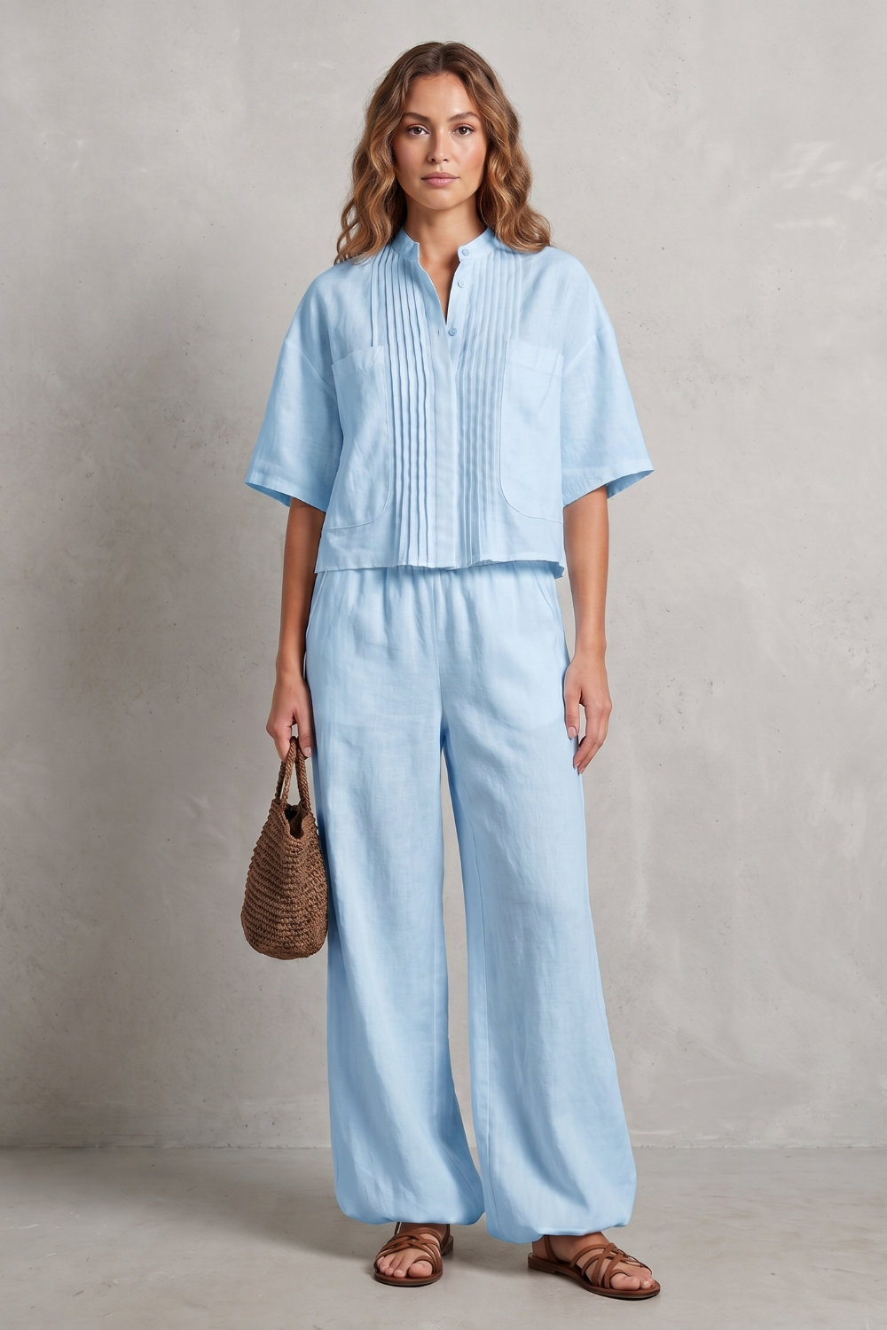 Pleated pants set styled with woven sandals for a resort look