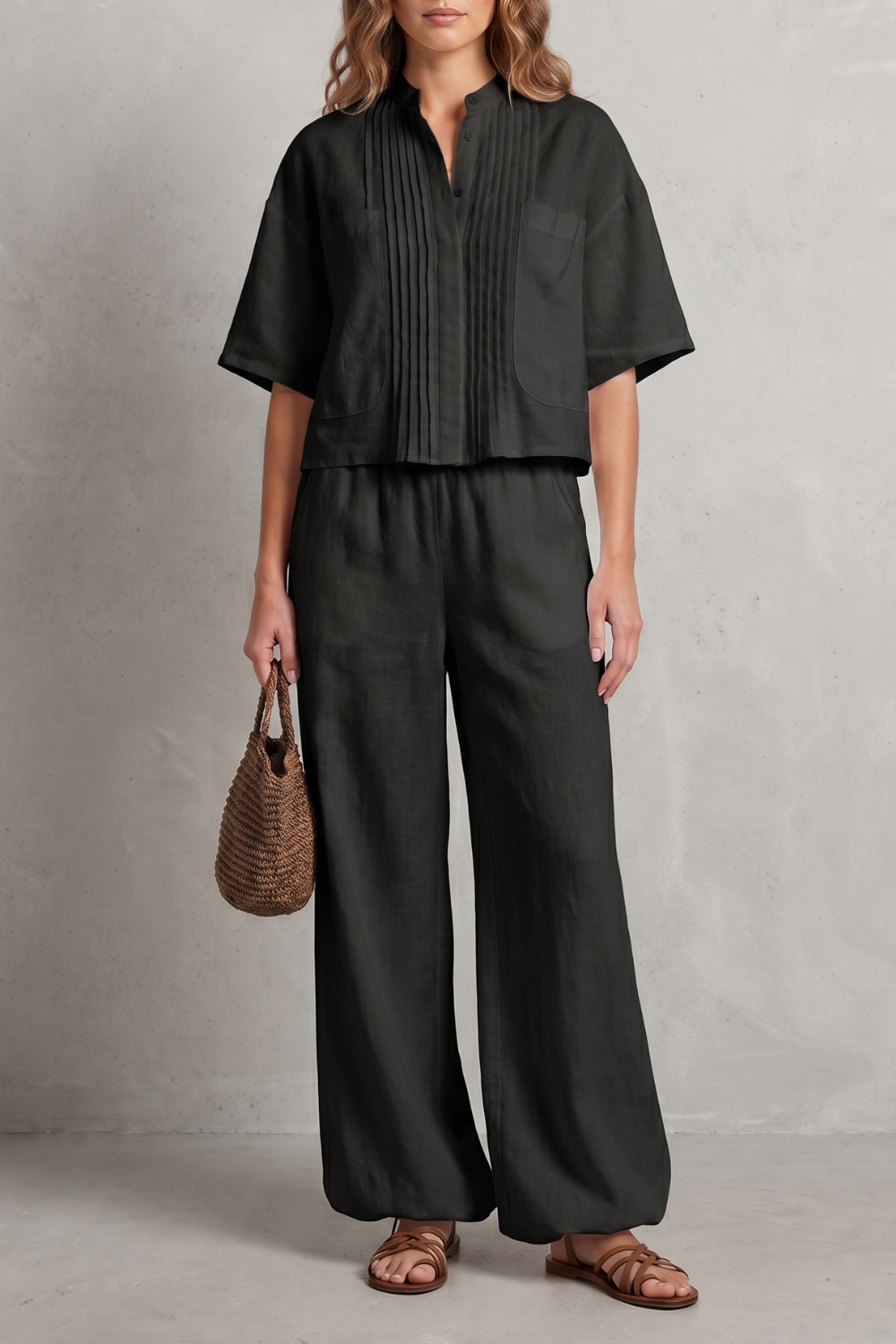 Seated view of the coordinated short-sleeve shirt and pleated pants set