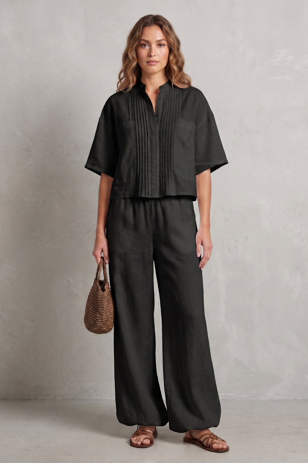 Full-length view of the two-piece pleated wide-leg pants set on model