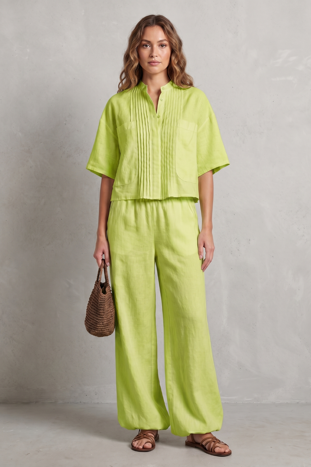 Side view of the pleated wide-leg pants showing the elongated silhouette