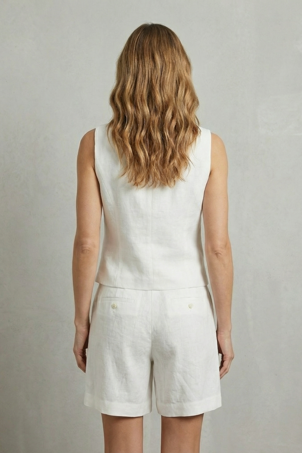 Detail close-up of the button-front placket on the V-neck vest
