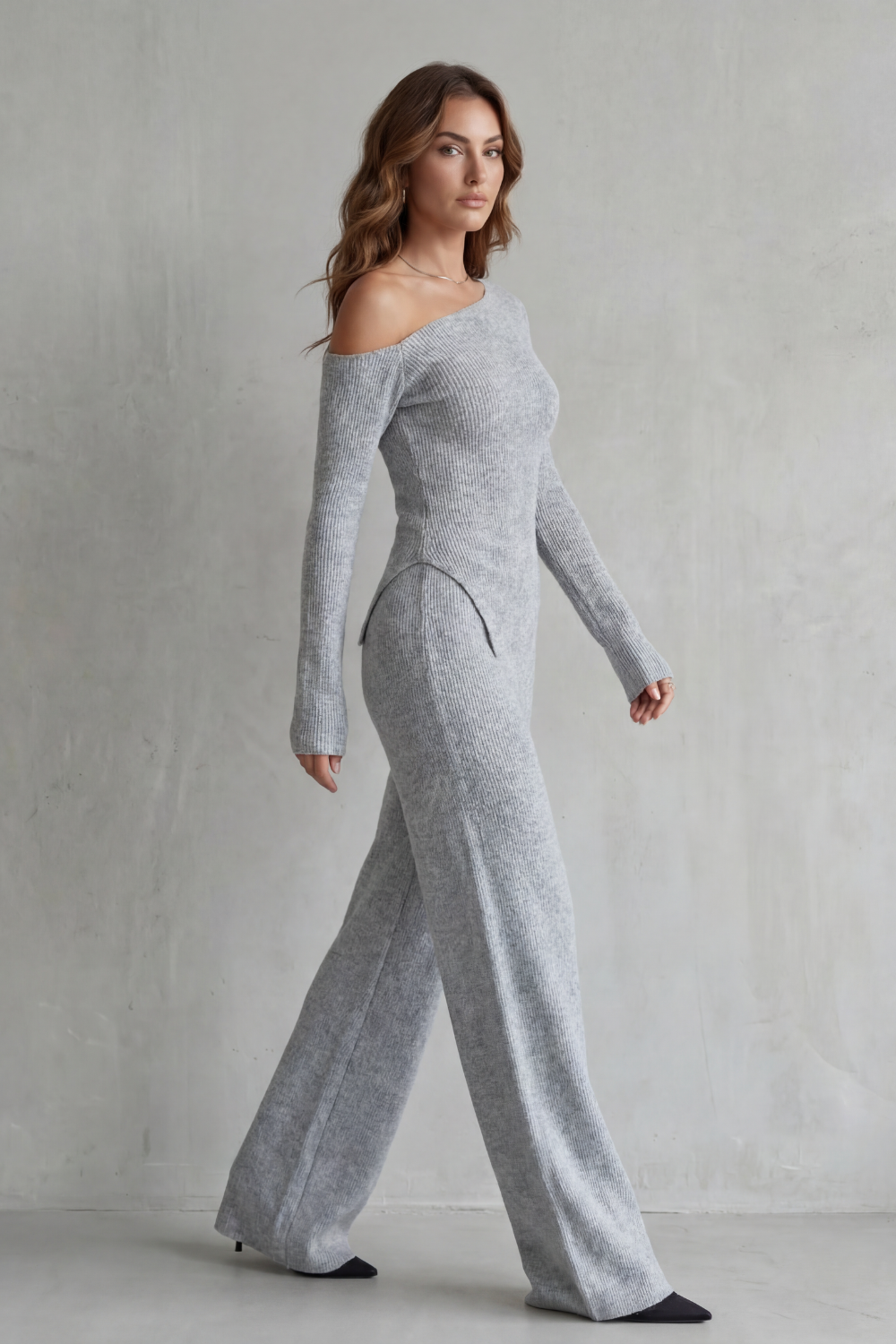 Back view of the asymmetrical knit top and high-waisted pants