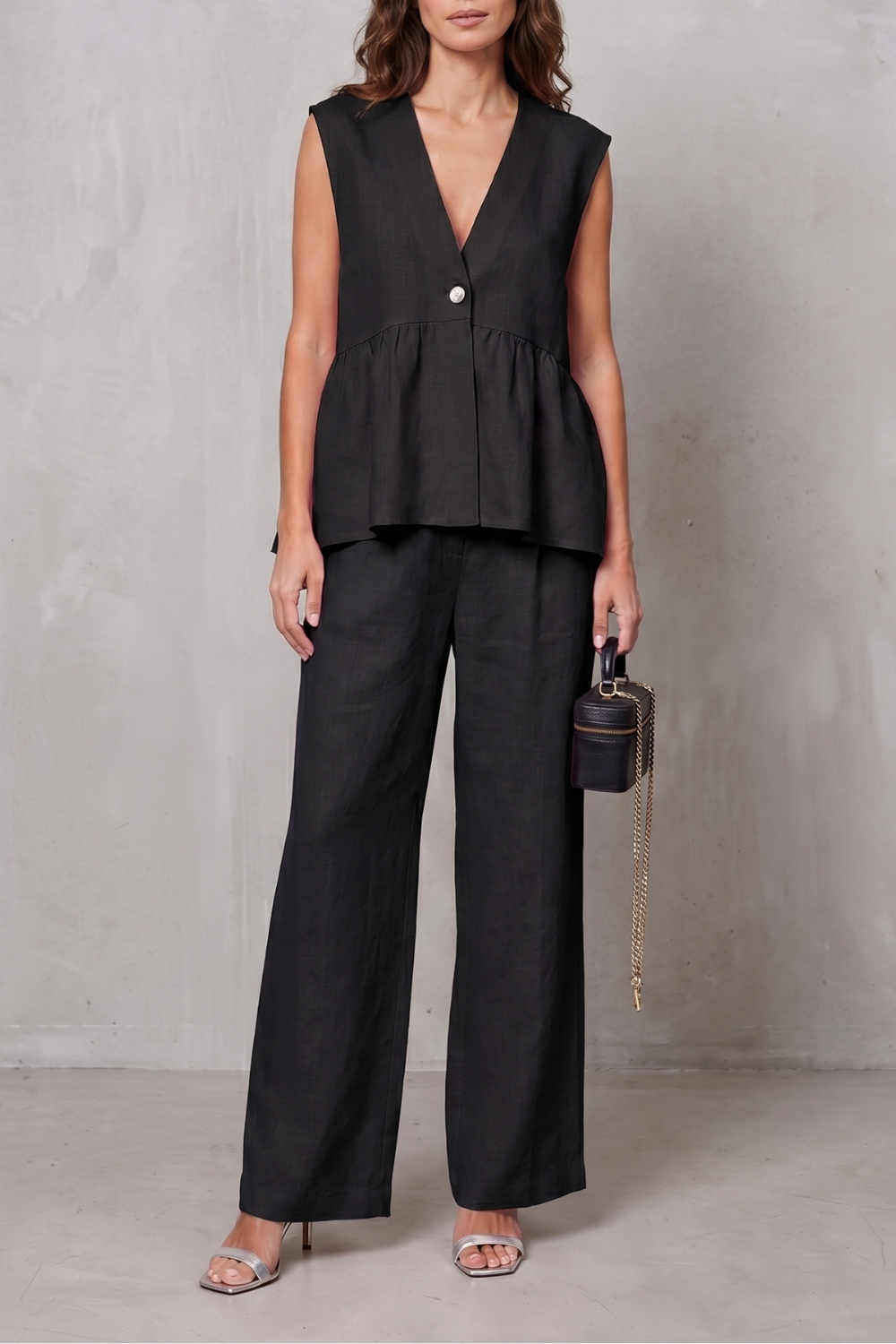 Black colorway of the sleeveless V-neck peplum top and pants set
