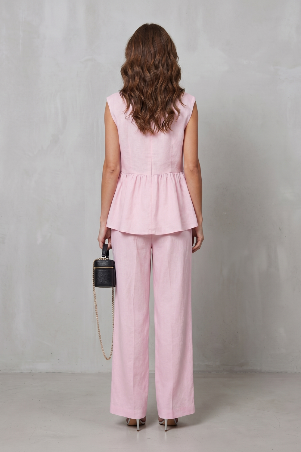 Detail close-up of the deep V-neckline on the peplum top
