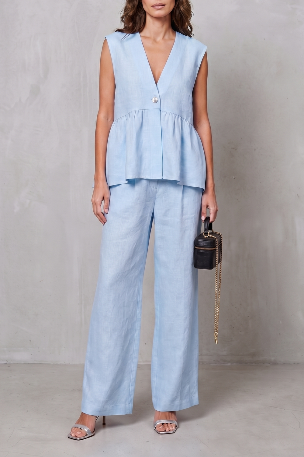 Three-quarter view of the sleeveless peplum two-piece set
